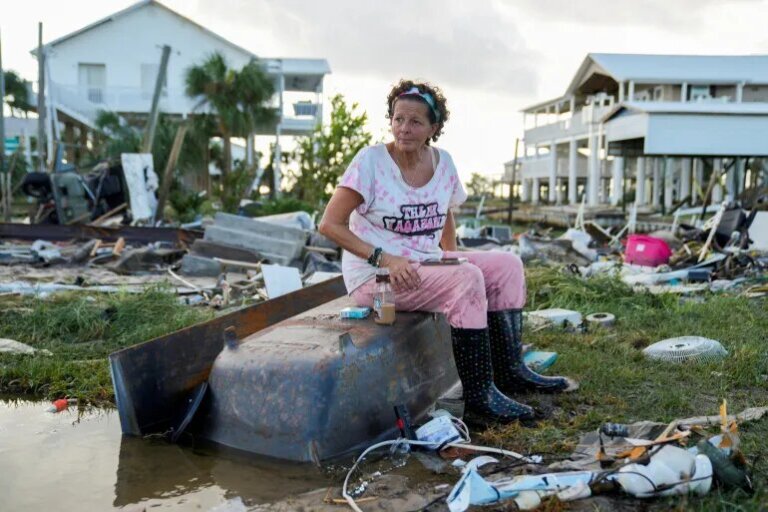 Jewell Baggett, 51, sits on a bathtub amid the wreckage of the home built by her grandfather, where she grew up and three generations of her family lived, in Horseshoe Beach, Florida, August 30, 2023 [Cheney Orr/Reuters]