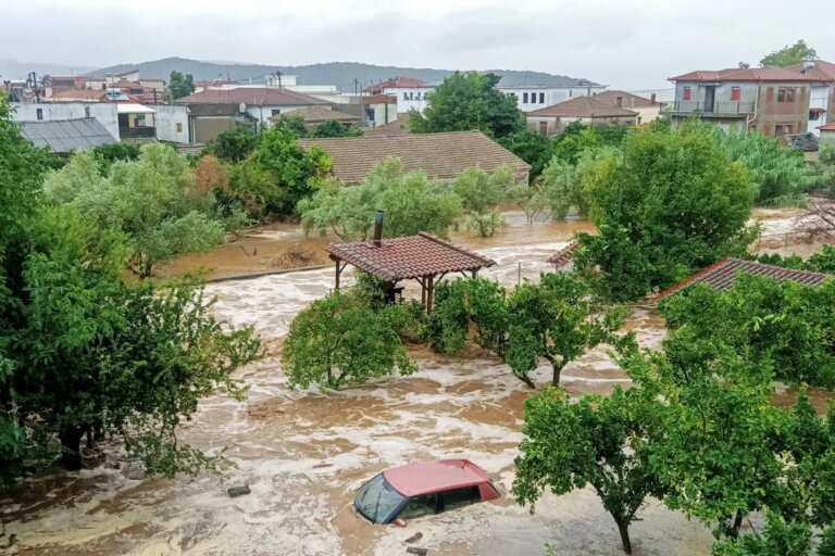 A car is submerged under water during a storm on Mount Pelion, near Volos. [Thanassis Kalliaras/Eurokinissi via Reuters]
