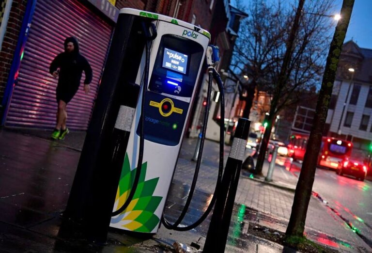 A man runs past a BP EV (Electric Vehicle) charge point in London, Britain, January 30, 2021. REUTERS/Toby Melville/File Phot